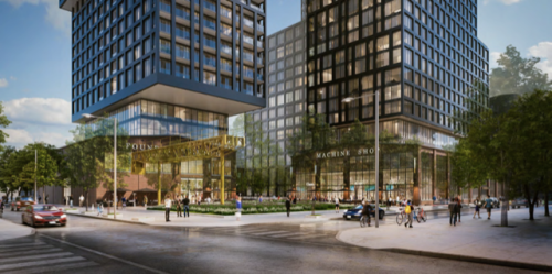 Glass buildings with several windows and surround trees along a busy intersection.