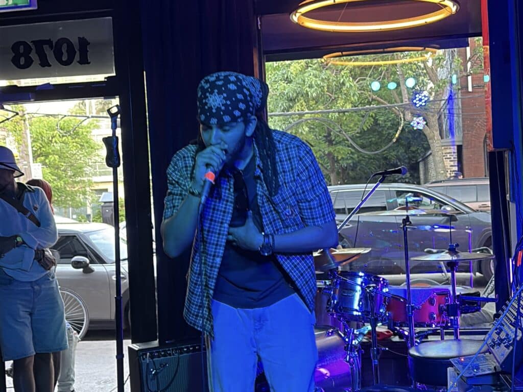 An image of artist Mikey Bloom performing at Poetry Jazz Cafe.