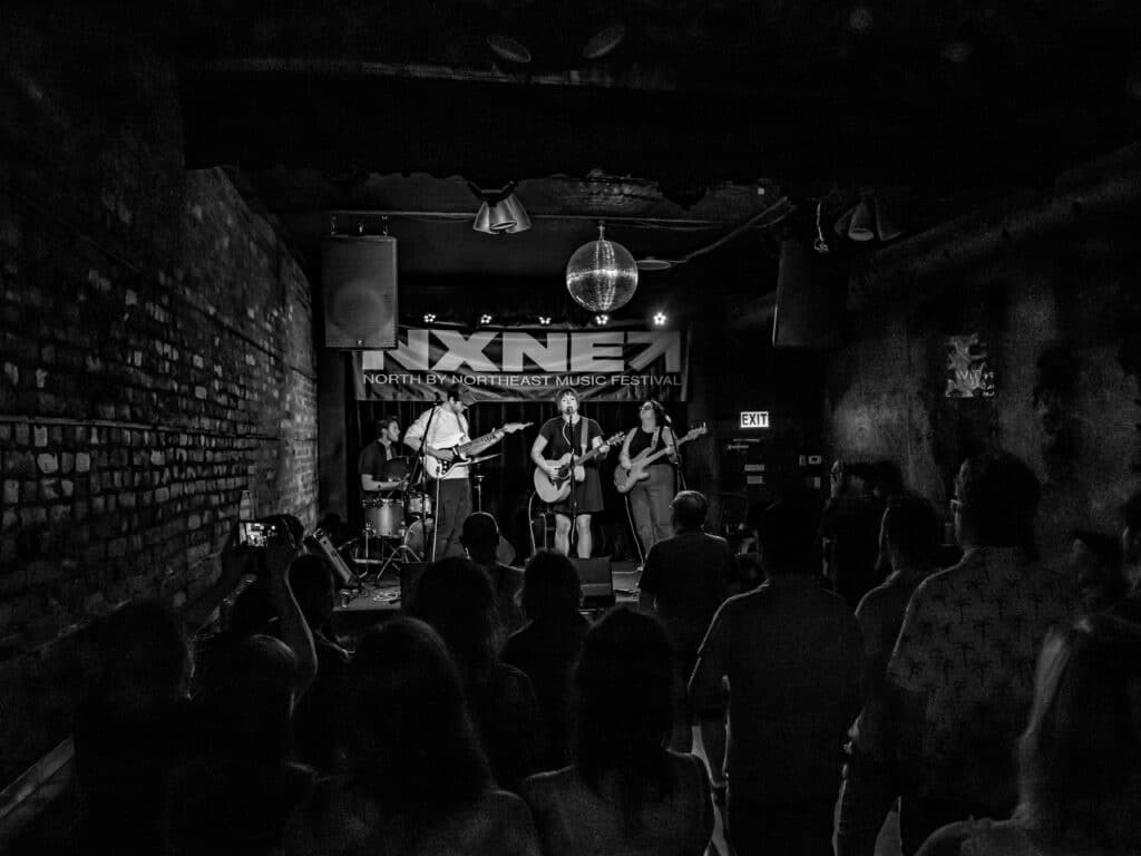 Alanna Matty and band performing to a packed crowd.